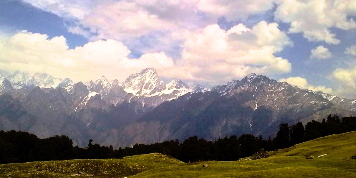 Seasonal contrast showing snow covered slopes and summer meadows